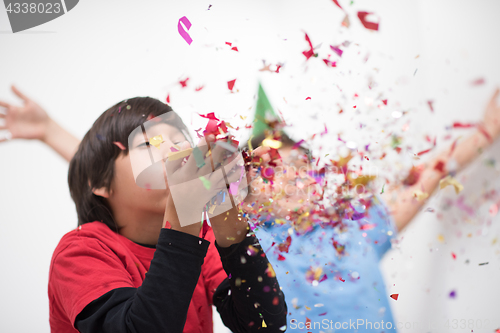 Image of kids  blowing confetti