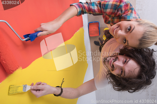 Image of couple painting interior wall