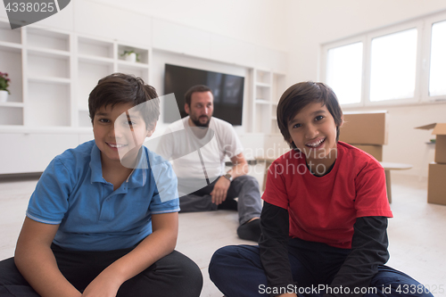 Image of portrait of happy young boys with their dad