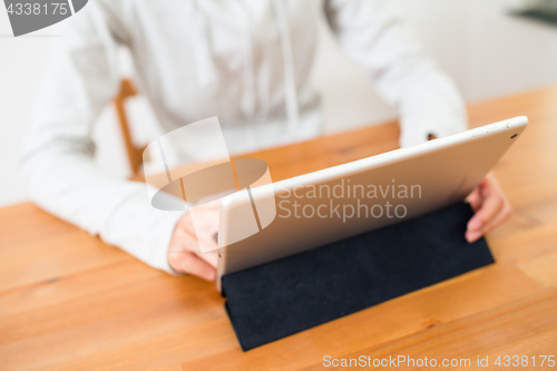 Image of Woman working on digital tablet