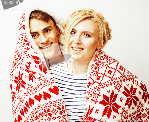 Image of young pretty teenage couple at Christmas time warming in red decorated blanket, hipster guy with his girlfriend happy smiling and hugging isolated on white background, lifestyle people concept 