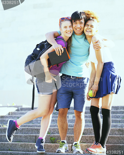 Image of cute group of teenages at the building of university with books 