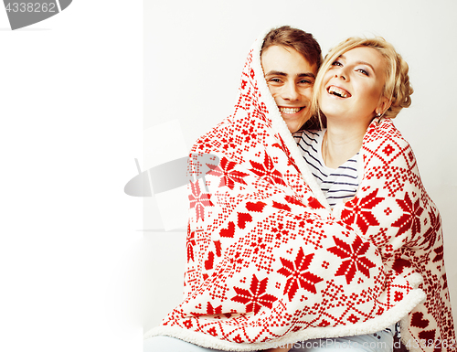 Image of young pretty teenage couple at Christmas time warming in red dec