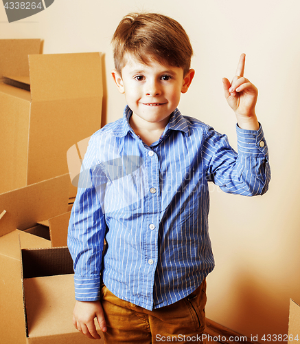 Image of little cute boy in empty room, remoove to new house. home alone,