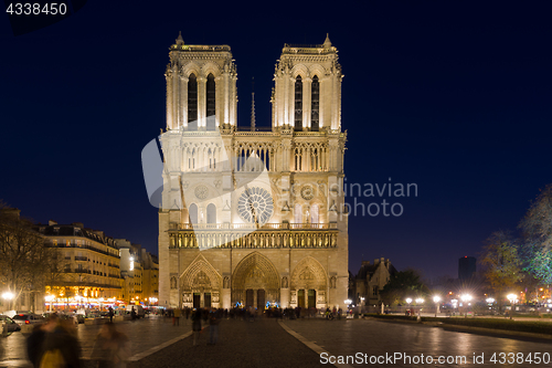 Image of Notre Dame Cathedral with Paris cityscape at dusk