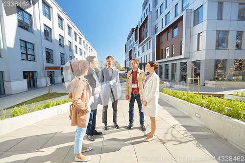 Image of business team with conference badges in city