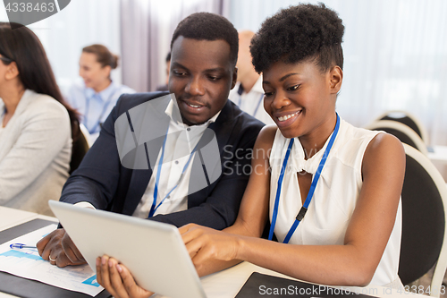 Image of team with tablet pc at business conference