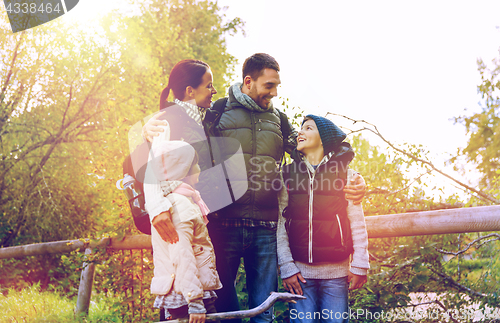 Image of happy family with backpacks hiking