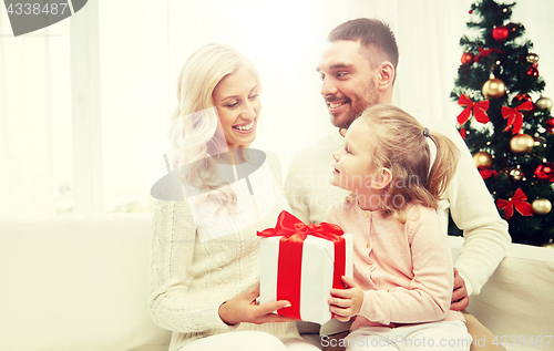 Image of happy family at home with christmas gift box