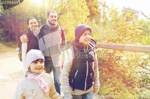 Image of happy family with backpacks hiking