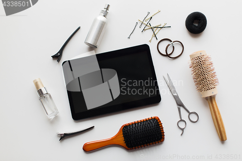 Image of tablet pc, scissors, brushes and other hair tools