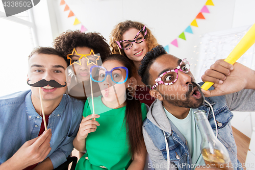 Image of happy friends or team having fun at office party