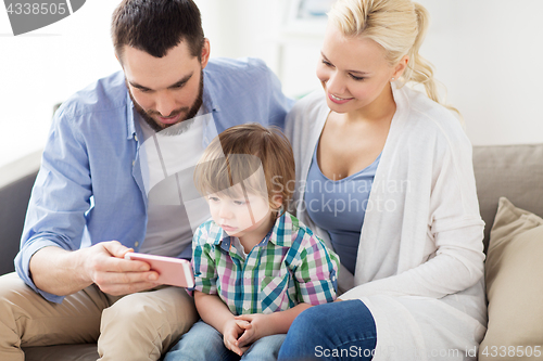 Image of happy family with smartphone at home
