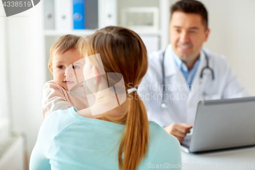 Image of woman with baby and doctor with laptop at clinic