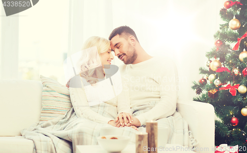 Image of happy couple at home with christmas tree