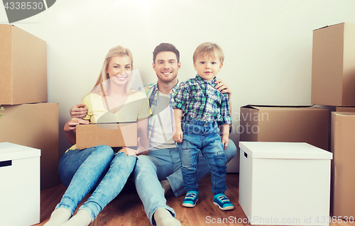 Image of happy family with boxes moving to new home