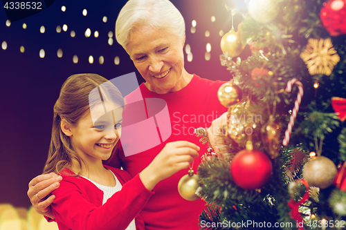 Image of happy family decorating christmas tree