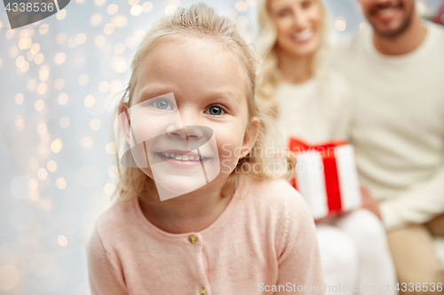 Image of happy little girl with family at christmas