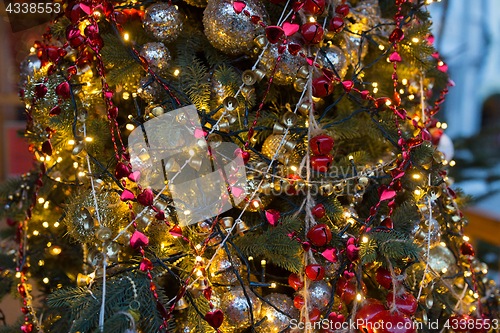 Image of close up of fir with christmas tree toys outdoors