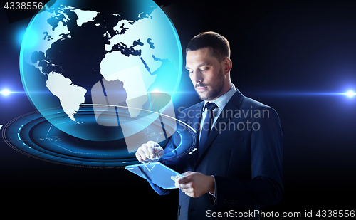 Image of businessman with tablet pc and earth hologram