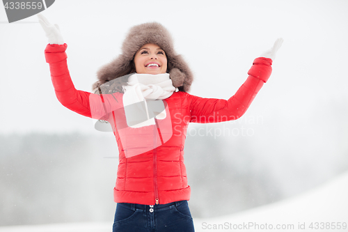 Image of happy woman in winter fur hat outdoors