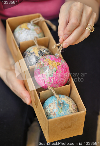 Image of Christmas balls shaped as globe in box