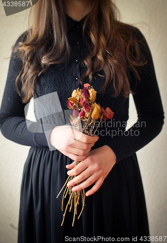 Image of Young girl in black vintage dress 