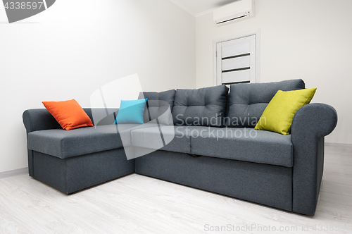 Image of White living room with grey sofa