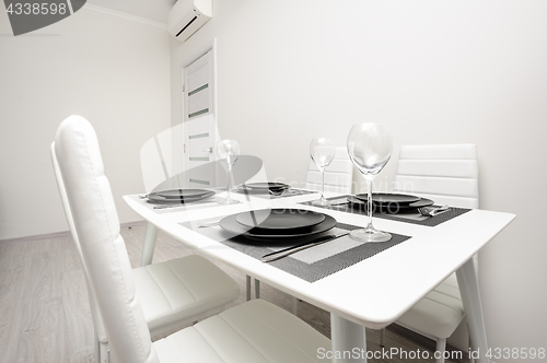 Image of minimalistic served white table