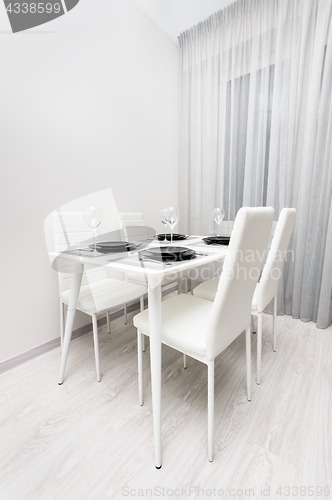 Image of minimalistic served white table