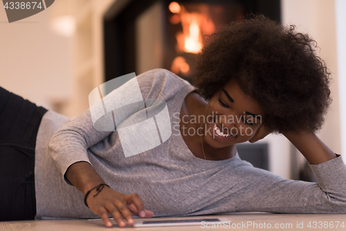 Image of black women using tablet computer on the floor