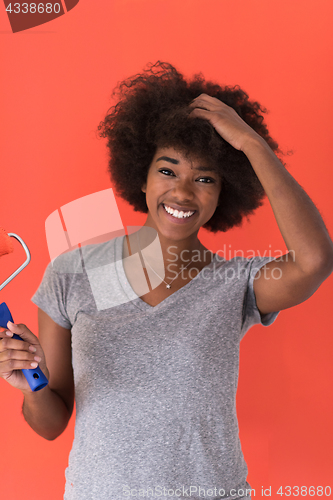 Image of black woman painting wall