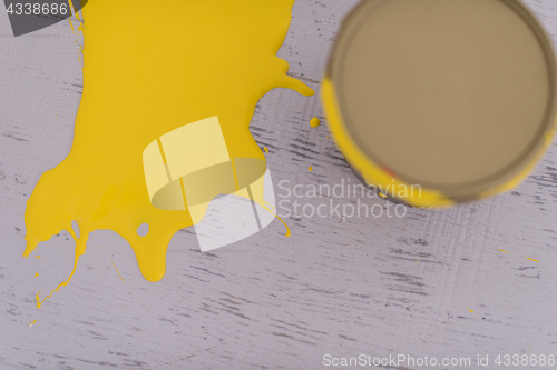 Image of Yellow paint tin can