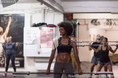 Image of black woman lifting empty bar