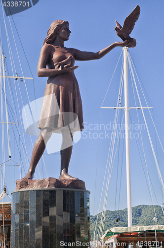 Image of MARMARIS, TURKEY - OCTOBER 19, 2013: Girl with a pigeon starue