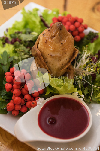 Image of quail roasted with sweet and sour cranberry sauce