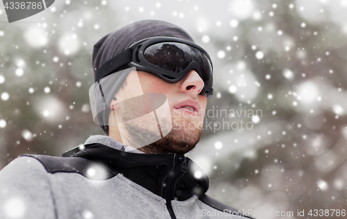 Image of sports man with ski goggles in winter outdoors