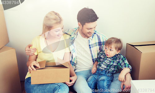 Image of happy family with boxes moving to new home