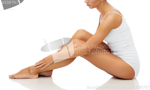 Image of beautiful woman touching her smooth bare legs