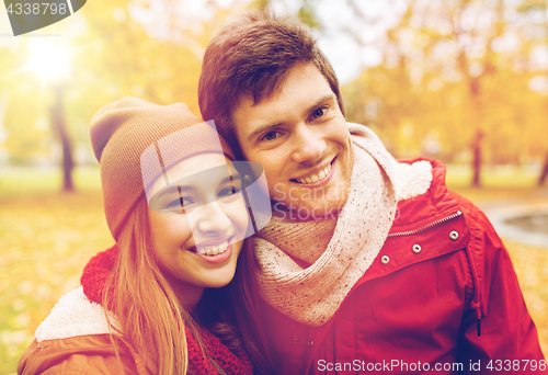 Image of happy young couple walking in autumn park