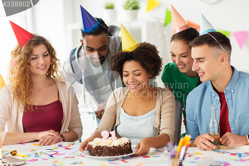 Image of team greeting colleague at office birthday party