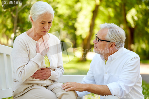 Image of senior woman feeling sick at summer park