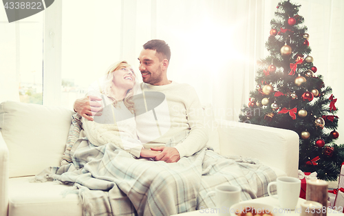 Image of happy couple at home with christmas tree