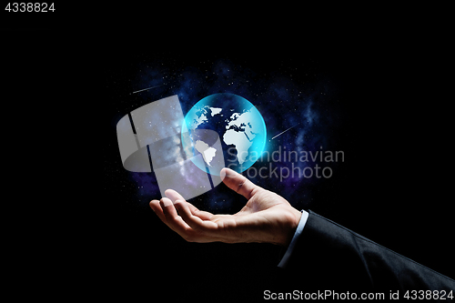 Image of close up of businessman hand with earth projection