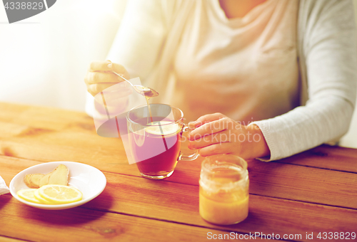 Image of close up of ill woman drinking tea with lemon