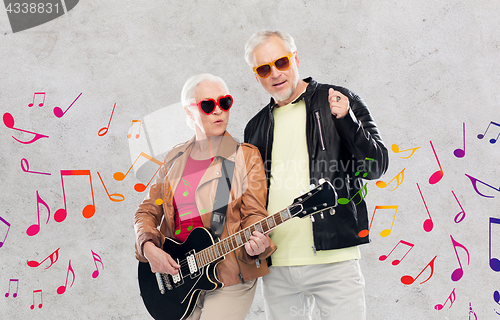 Image of senior couple in sunglasses with electric guitar