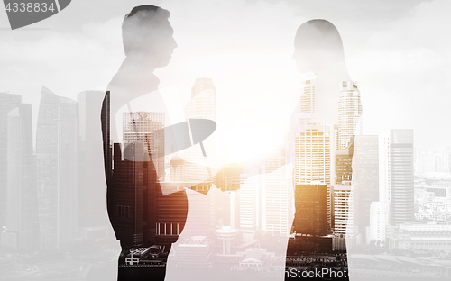 Image of business people shaking hands over city background