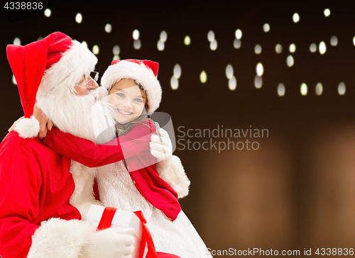 Image of santa claus with christmas gift and happy girl