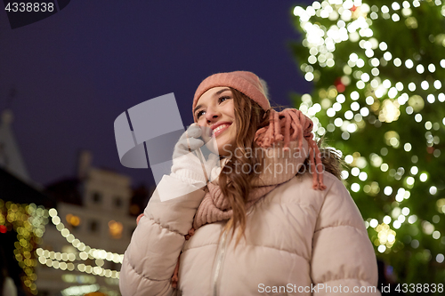 Image of happy woman calling on smartphone at christmas