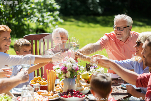 Image of happy family having dinner or summer garden party